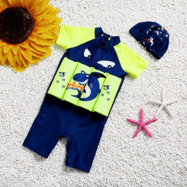 Baby swim outfit with life jacket, hat, and sunflower on a textured surface