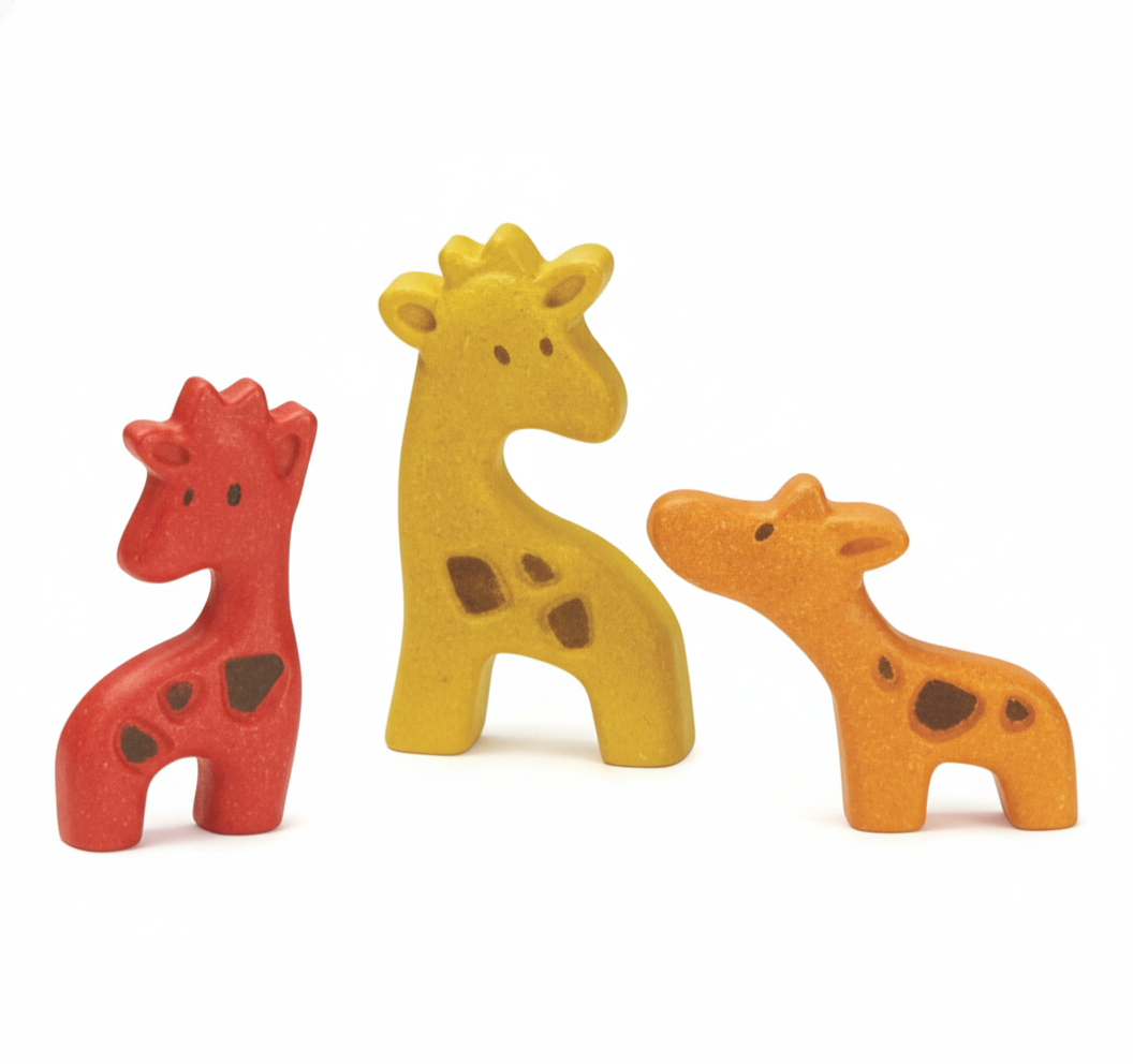 Three wooden giraffe toys in red, yellow, and orange on a white background