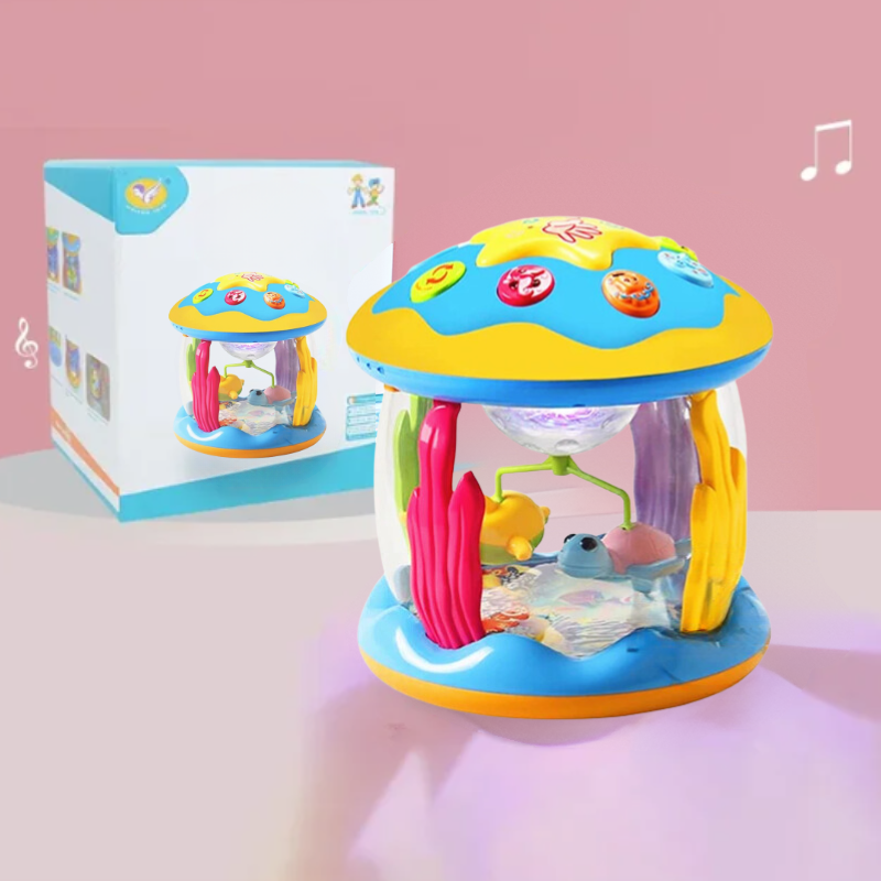 Colorful baby toy with music box and packaging on a pink background