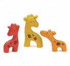 Three wooden giraffe toys in red, yellow, and orange on a white background