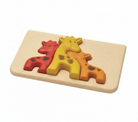 Wooden puzzle with three giraffe pieces on a beige base