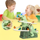 Two children playing with a dinosaur toy set on a yellow surface.