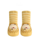Pair of yellow baby socks with cartoon design on a white background