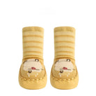 Pair of yellow baby socks with cartoon design on a white background