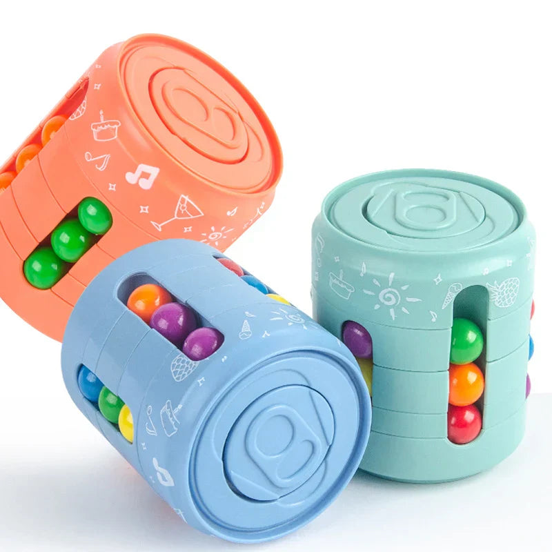 Colorful cylindrical toys with embedded beads on a white background