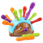 Colorful hedgehog toy with extendable arms on a white background
